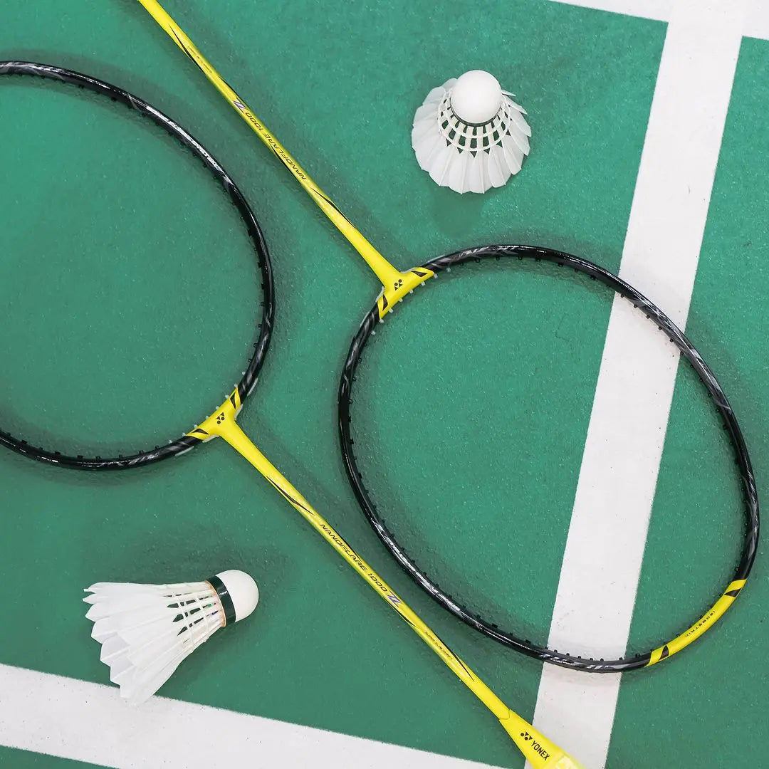 Yonex-Nanoflare-1000-Z-_Lightning-Yellow Two Rackets with Shuttlecock on the Court